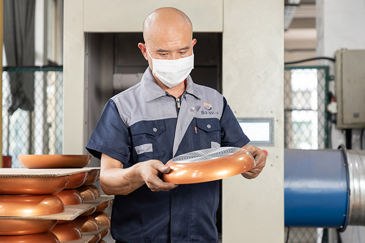 a dedicated worker inspects frying pan